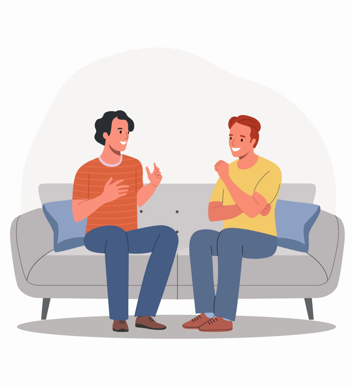 Men discussing while sitting on a couch.